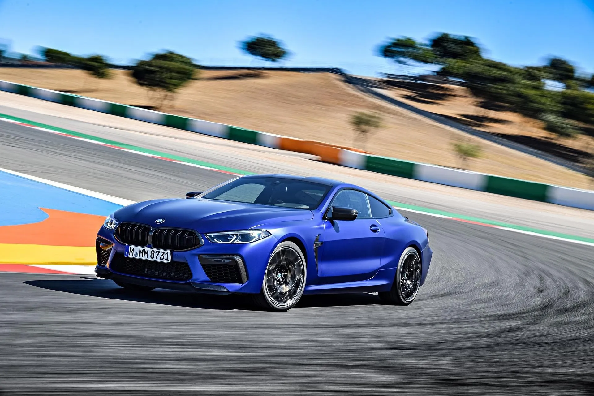Blue Bmw Racing on a Curvy Track at Speed Wallpaper