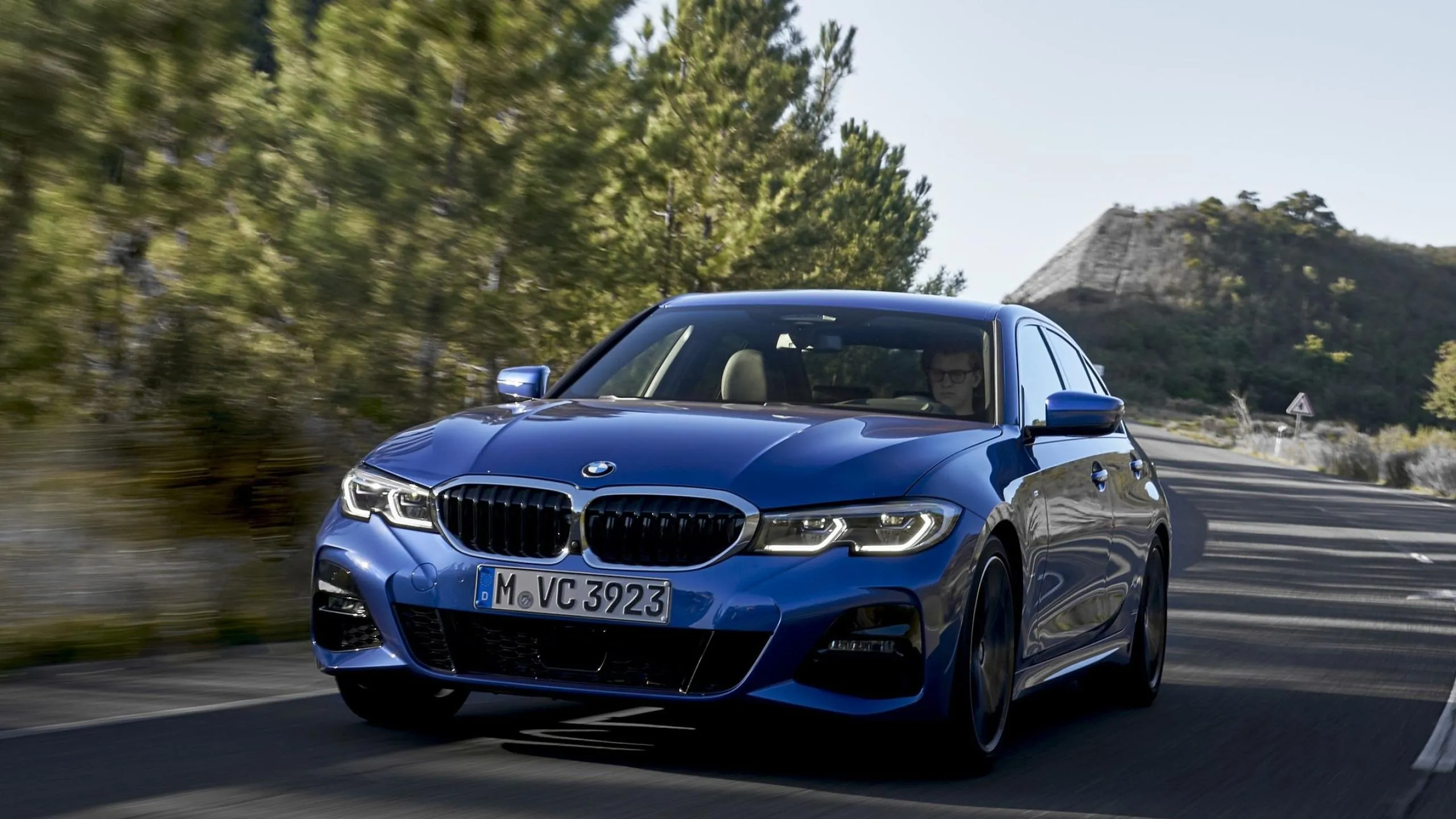 Blue Bmw Sedan Driving Fast on Scenic Mountain Road