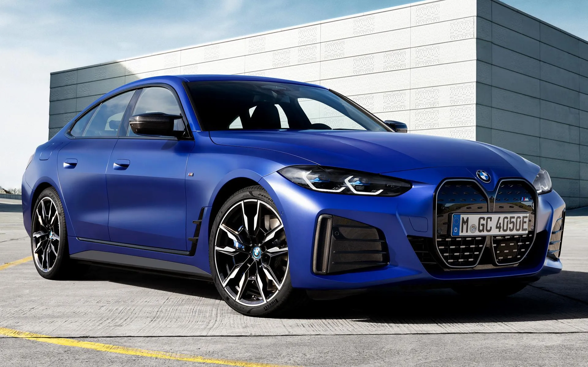 Blue Bmw Sedan Parked Near Modern Architecture Building