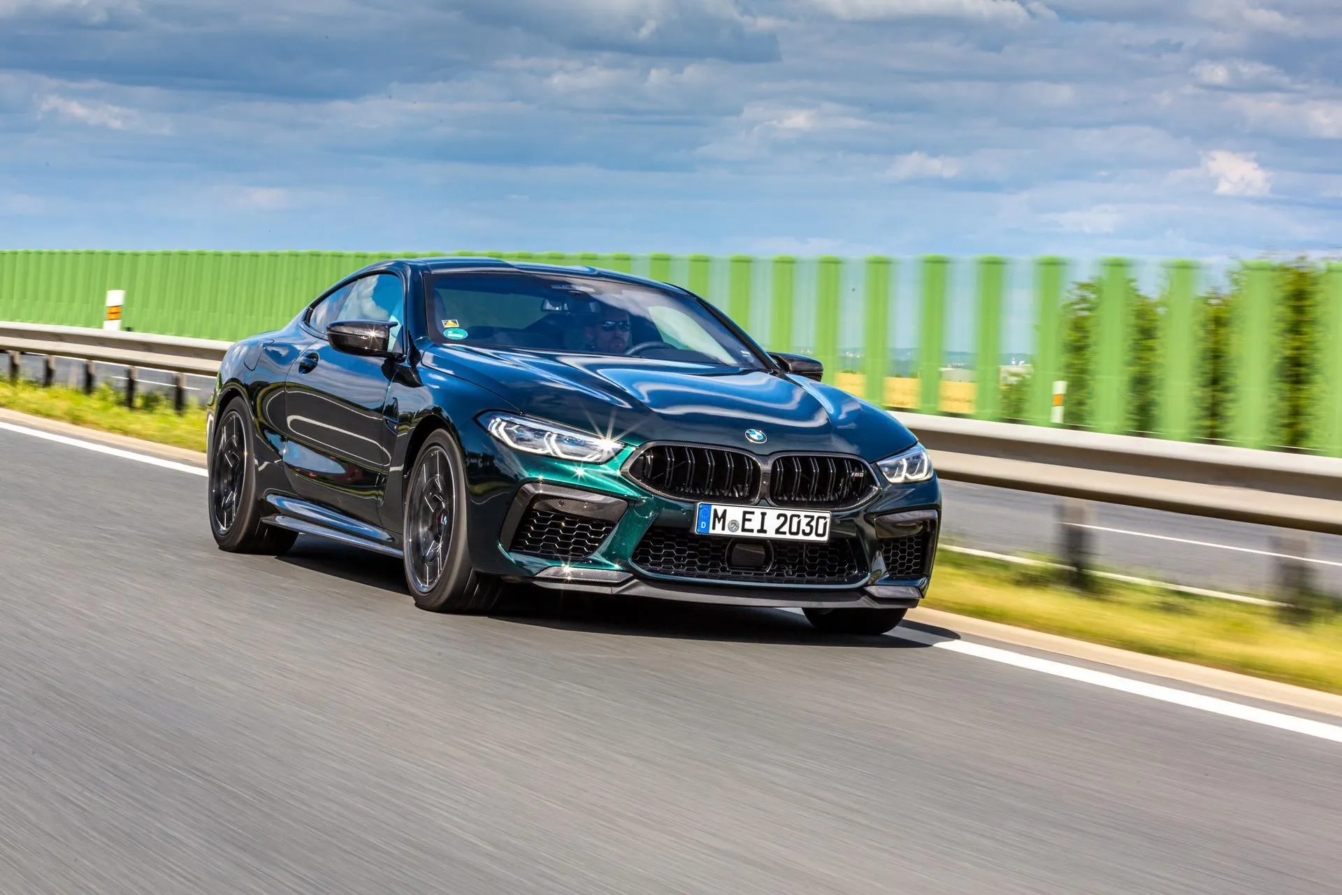 Blue Bmw Sedan Racing on Highway Under Bright Sunny Sky