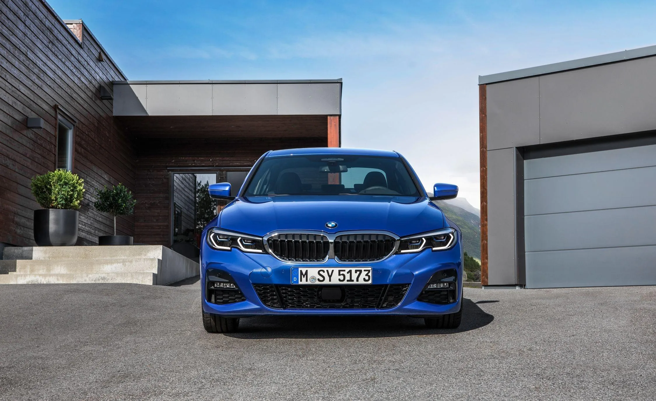 Blue Bmw Sports Car in Modern Driveway Front View Image
