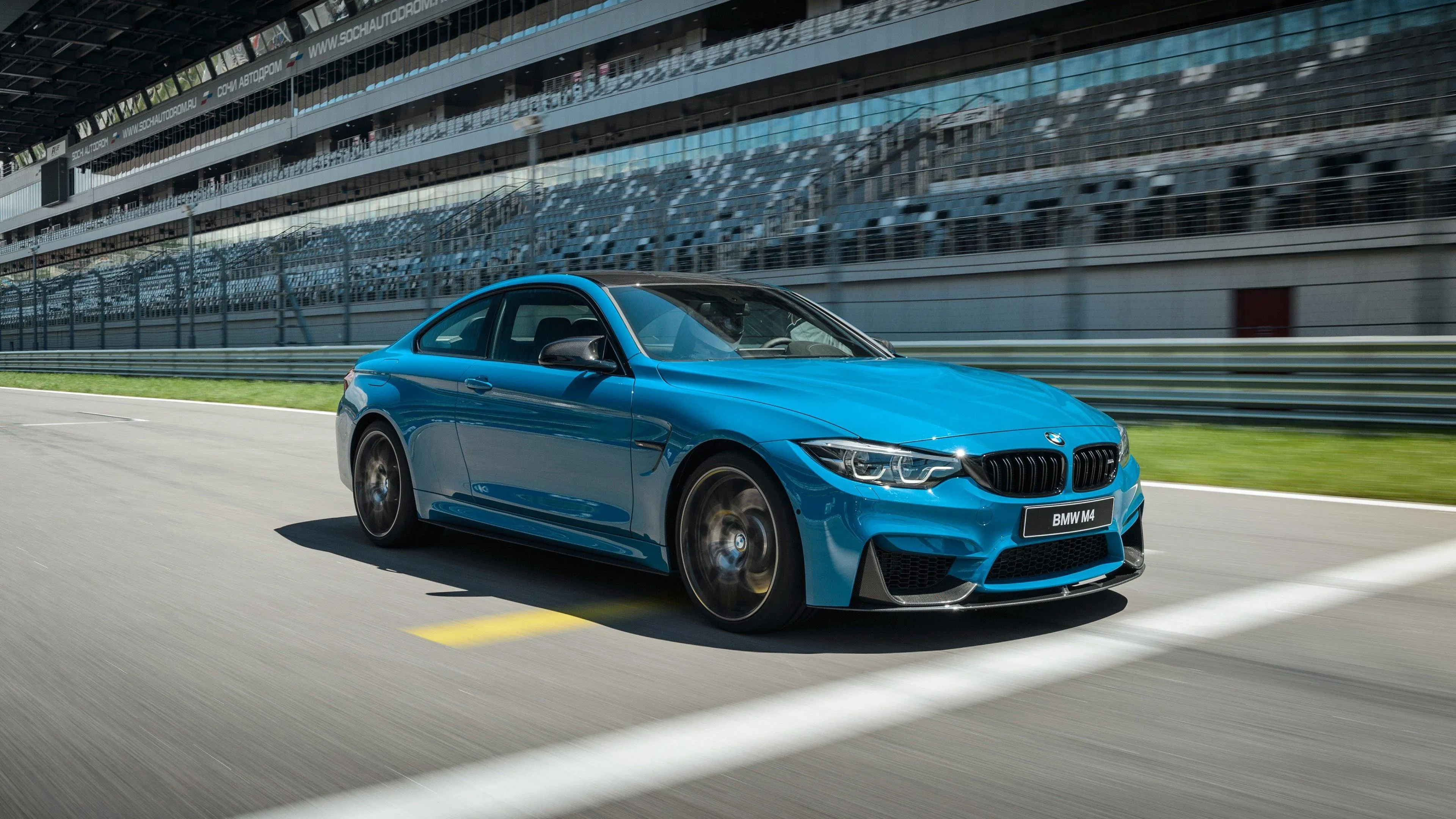 Blue Bmw Sports Car on Racetrack Moving at High Speed