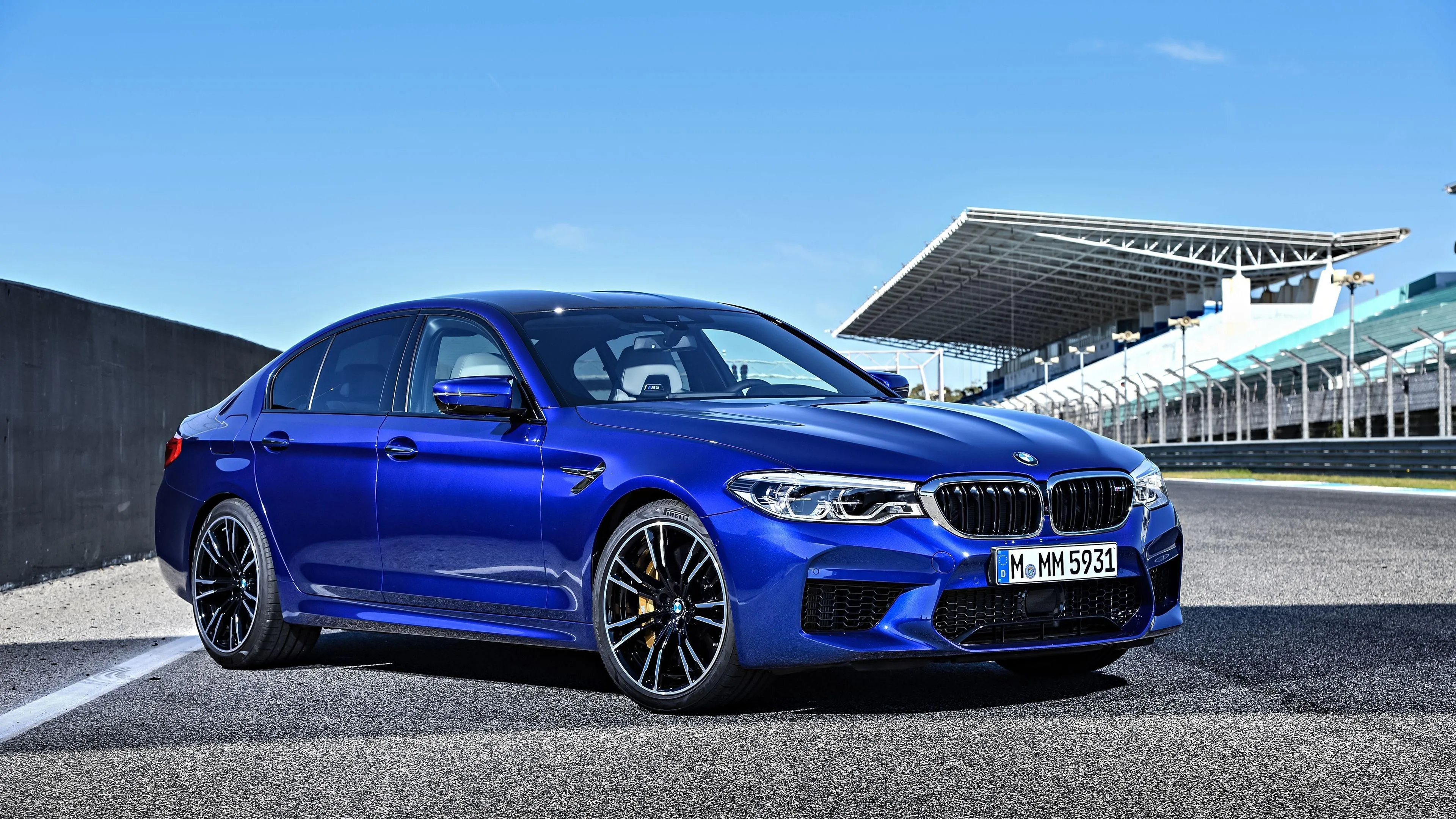 Blue Bmw Sports Car Parked at a Modern Trackside Location