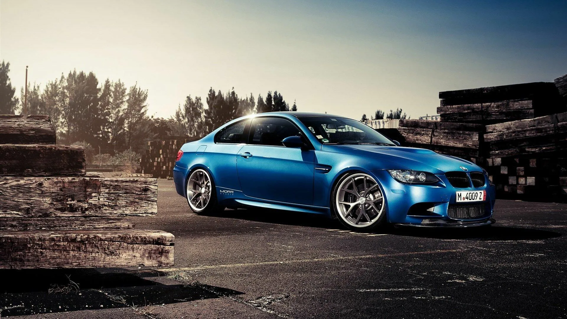 Blue Bmw Sports Car Parked on Road with Ruins in the Backdrop