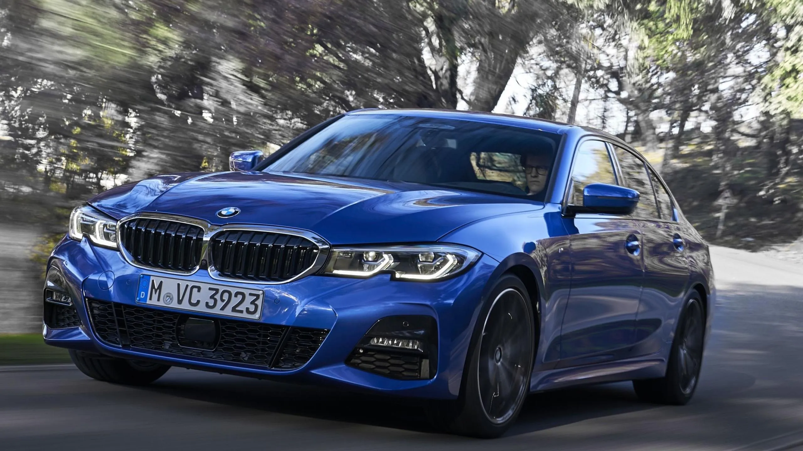 Blue Bmw Sporty Coupe Cruising Through Forest Road