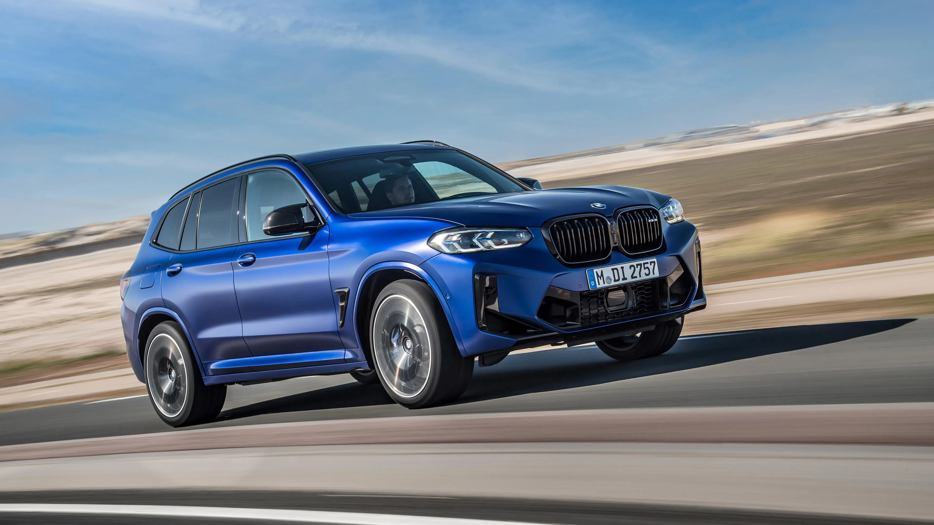 Blue Bmw Suv Driving Fast on a Highway Under Blue Sky