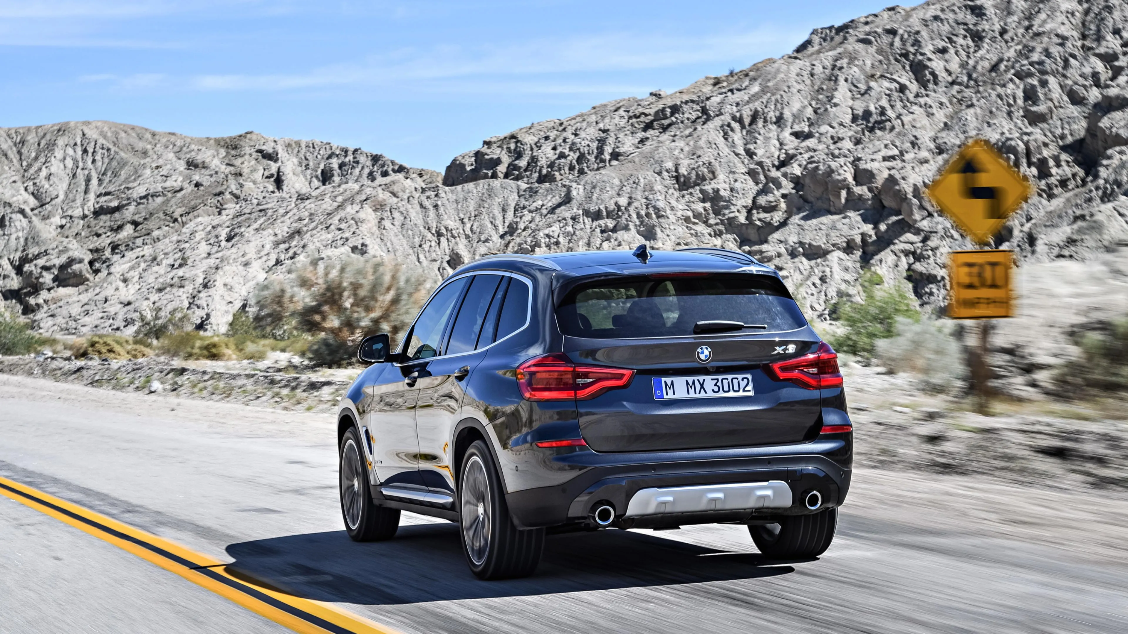 Blue Bmw Suv Driving on a Mountain Highway in Daylight