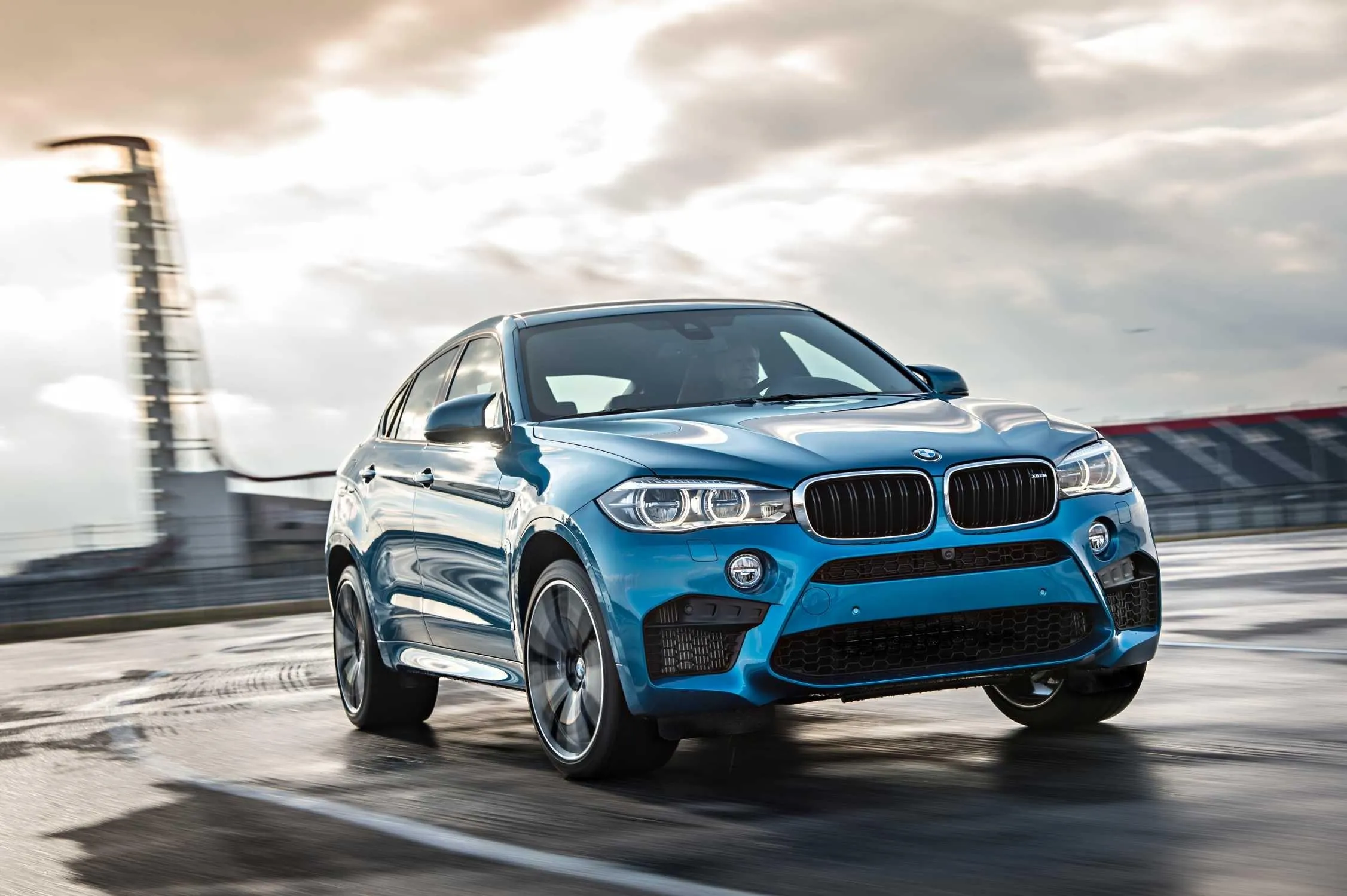 Blue Bmw Suv Driving on a Road Near the Lighthouse Image