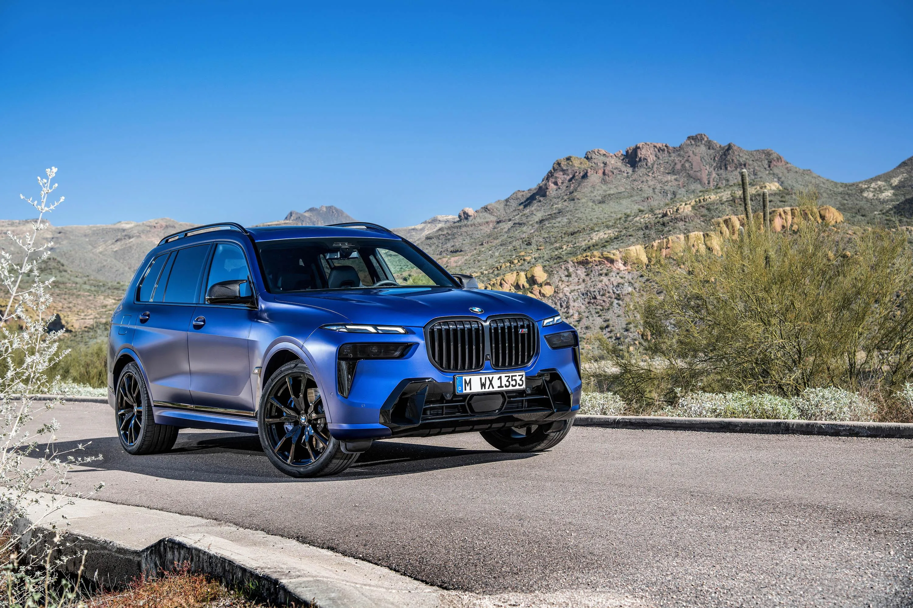 Blue Bmw Suv Driving on Mountain Road in Clear Weather