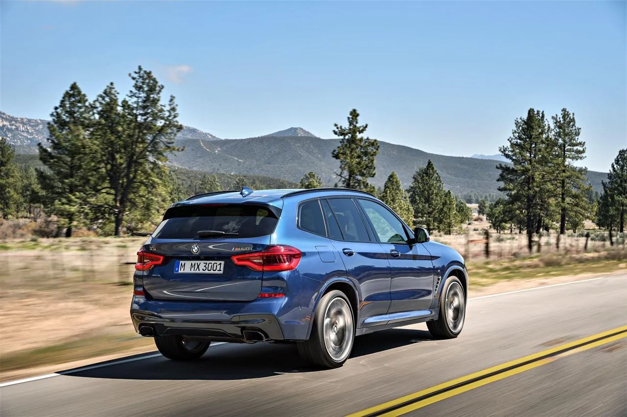 Blue Bmw Suv Driving on Mountain Road with Trees Around