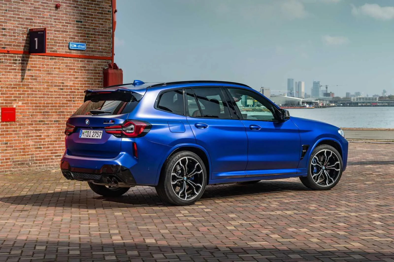 Blue Bmw Suv on City Road with Modern Skyline Hd Image