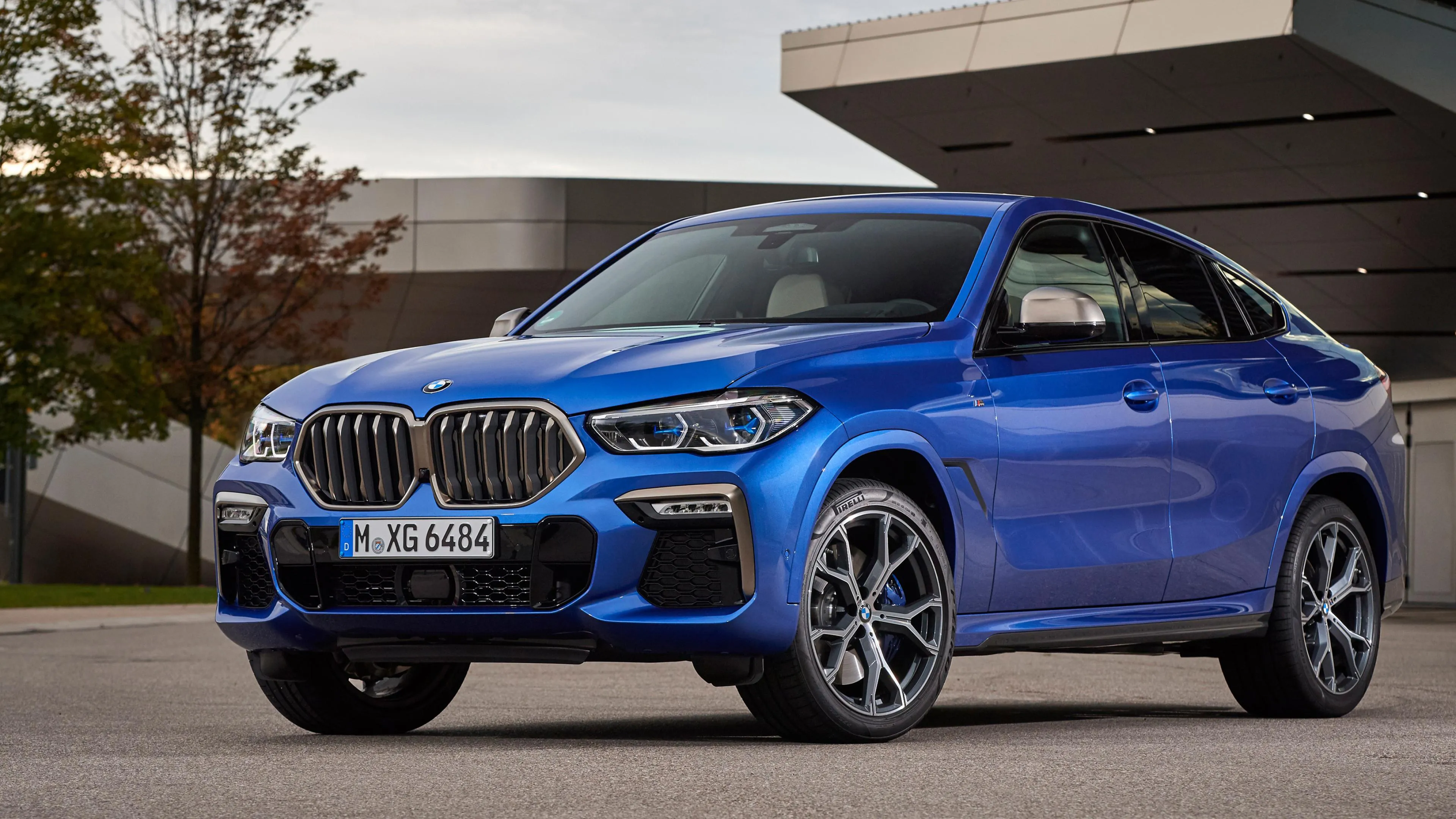 Blue Bmw Suv Parked in Front of Modern Office Building