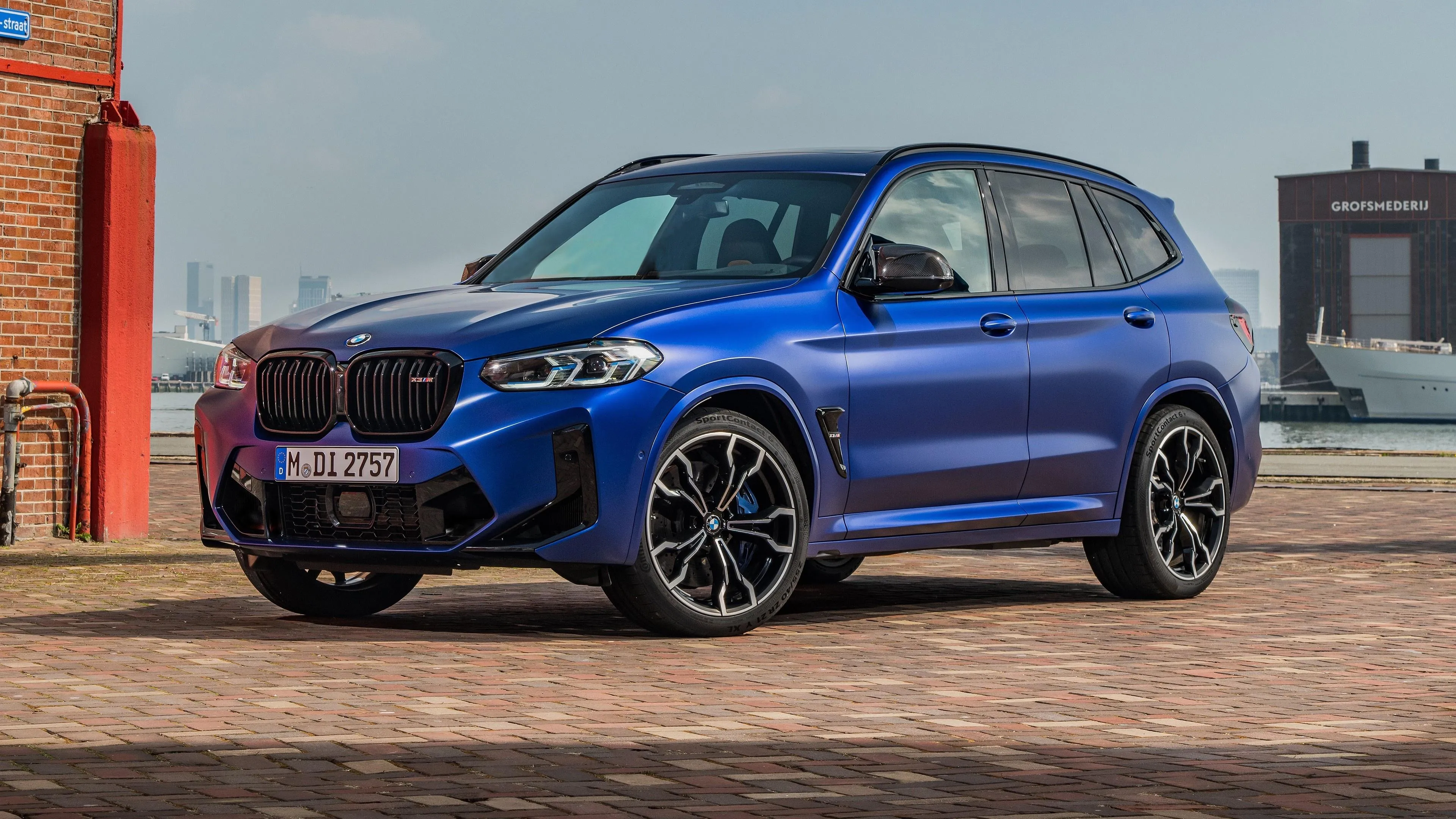 Blue Bmw Suv Parked Near Construction Area Under Daylight