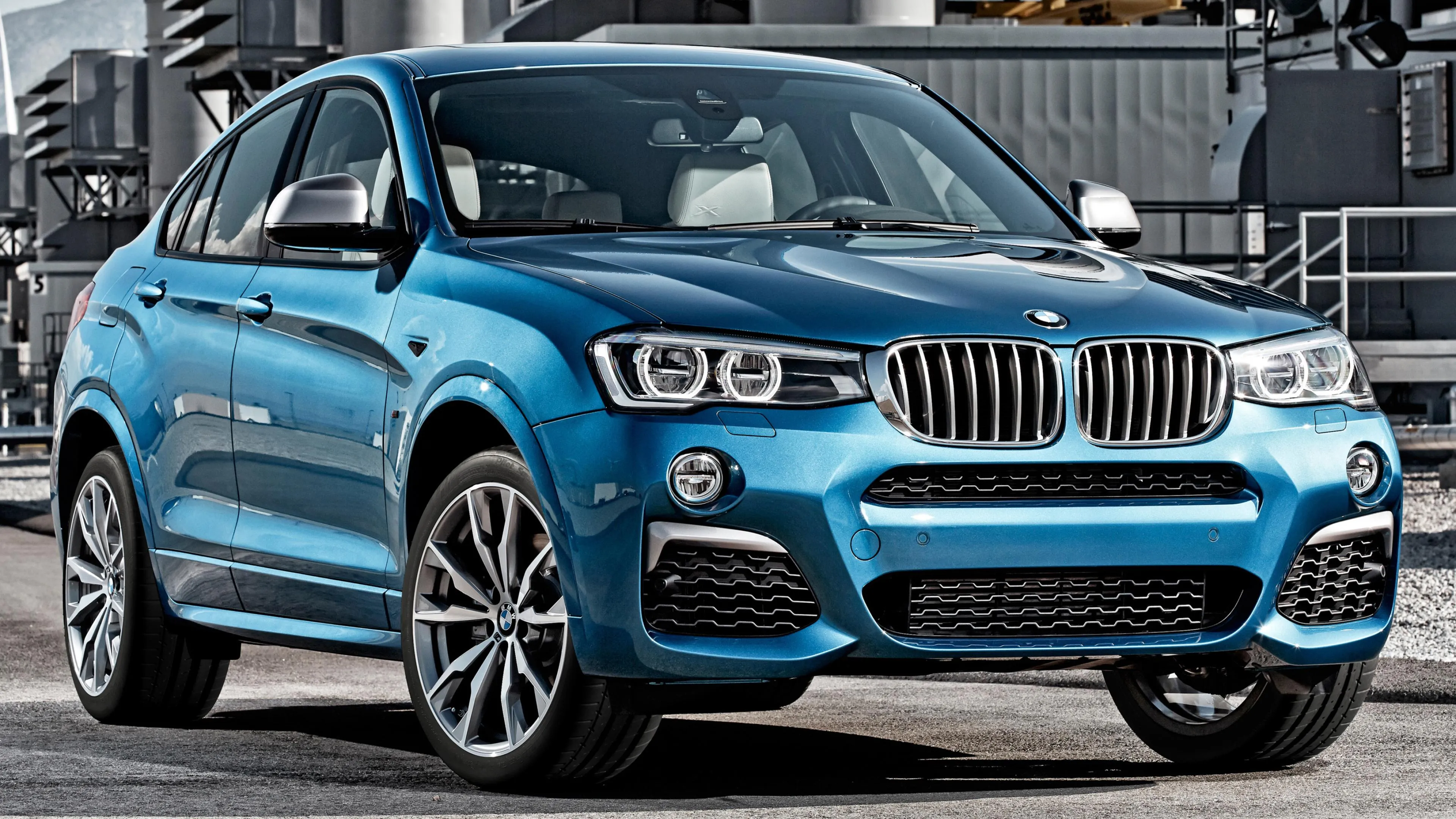Blue Bmw Suv Parked Outside Modern Home in Daylight