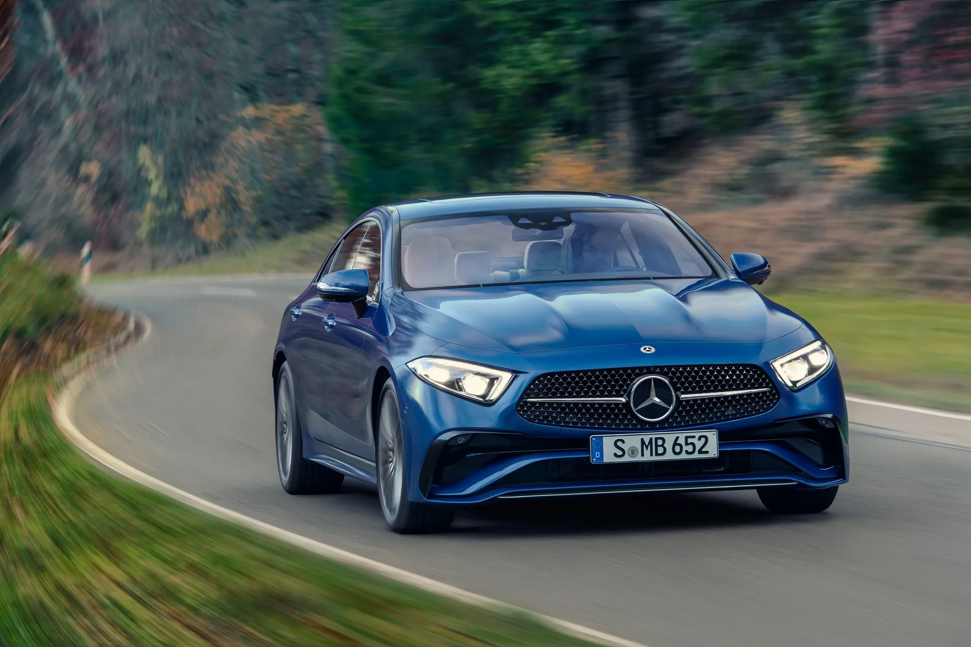 Blue Mercedes Benz Driving on a Mountain Curve Road