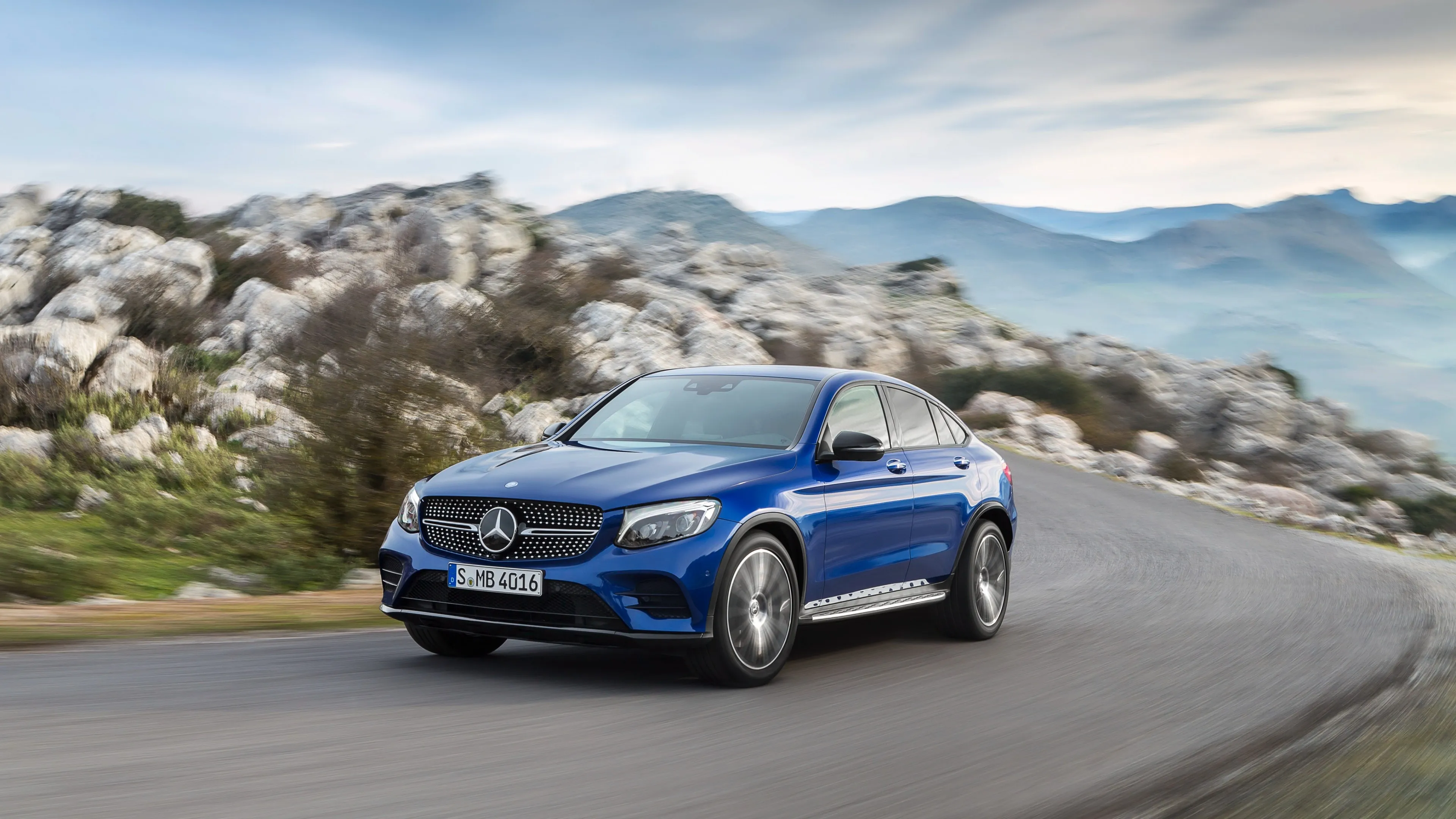 Blue Mercedes Benz SUV Driving on Mountain Road image