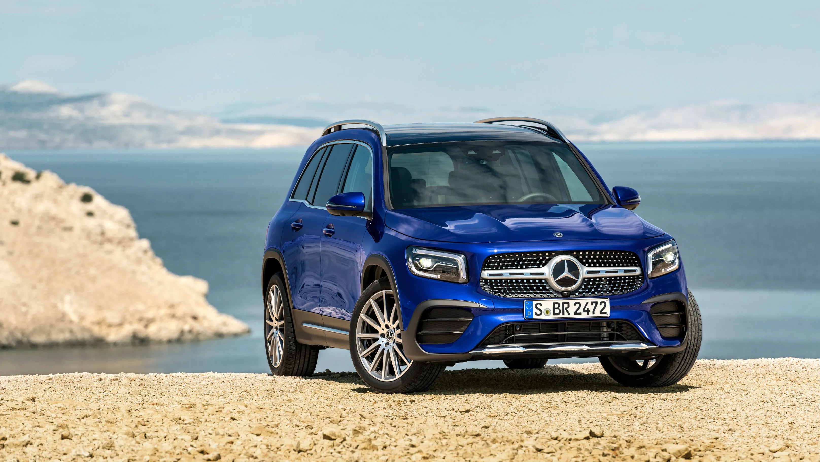 Blue Mercedes Benz SUV Parked by Cliff and Ocean View