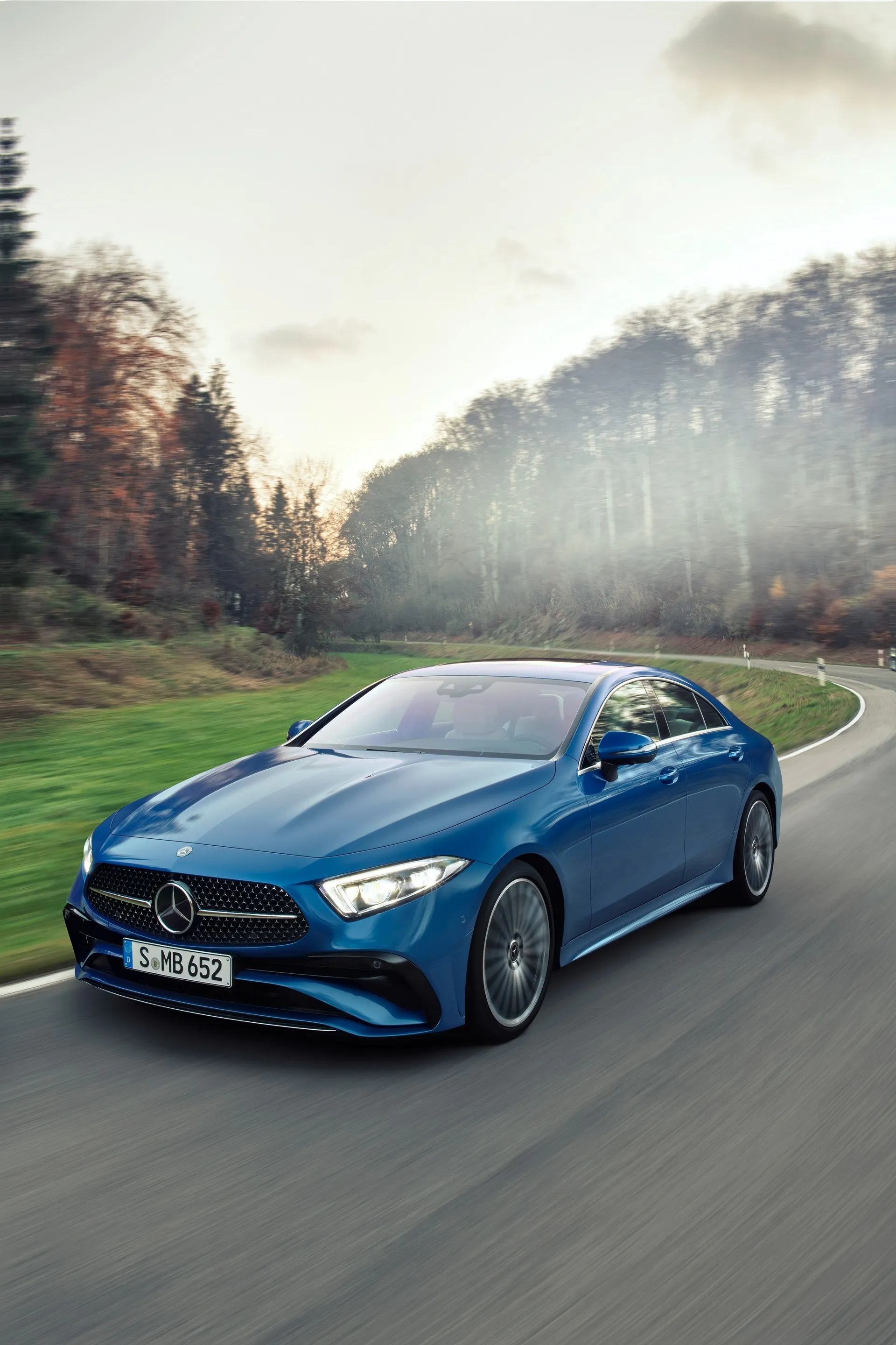 Blue Mercedes Driving Fast Through Forest Road Wallpaper