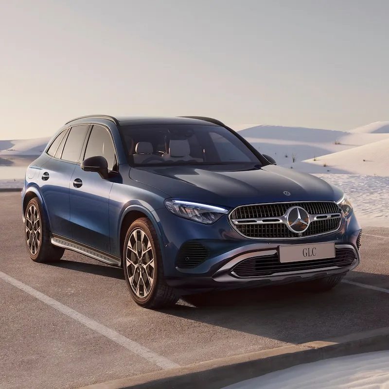 Blue Mercedes SUV Parked in a Snowy Landscape free image