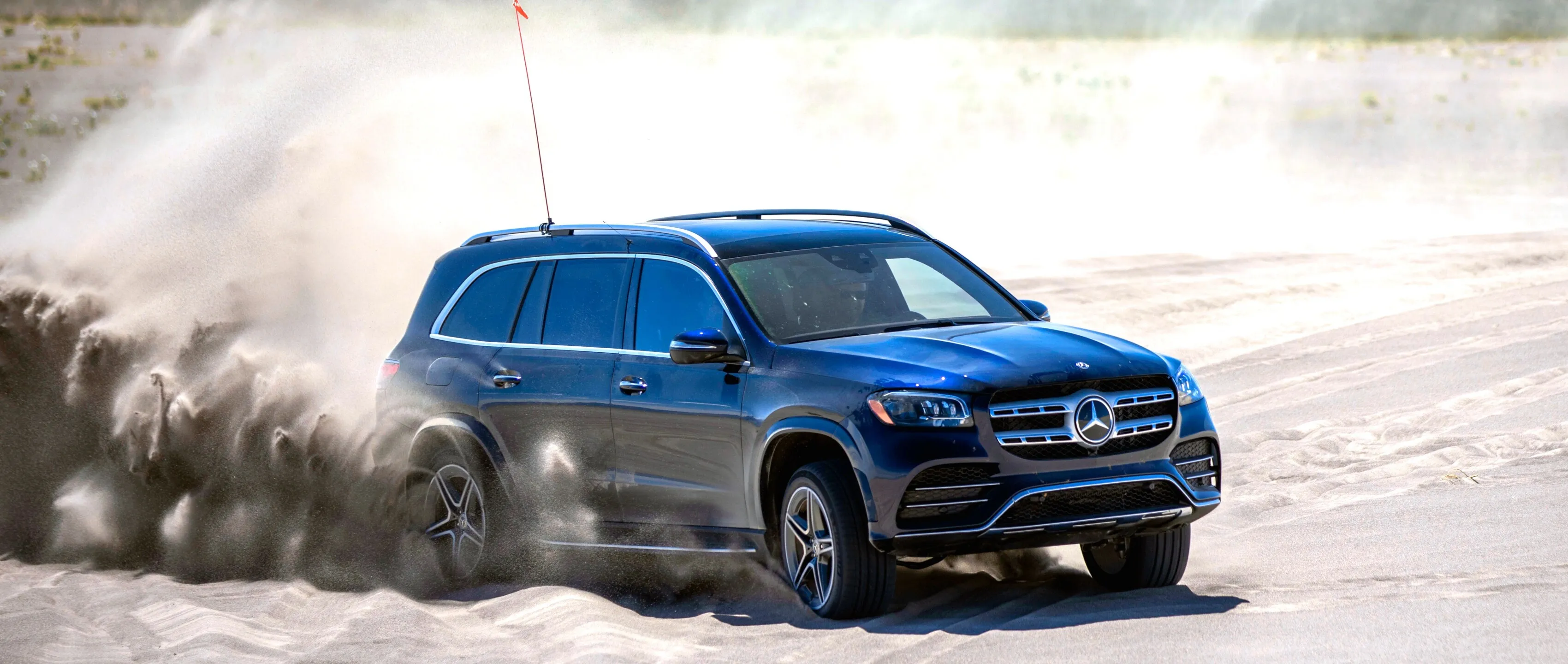 Blue Mercedes SUV Racing Off Road in Desert Sand Wallpaper