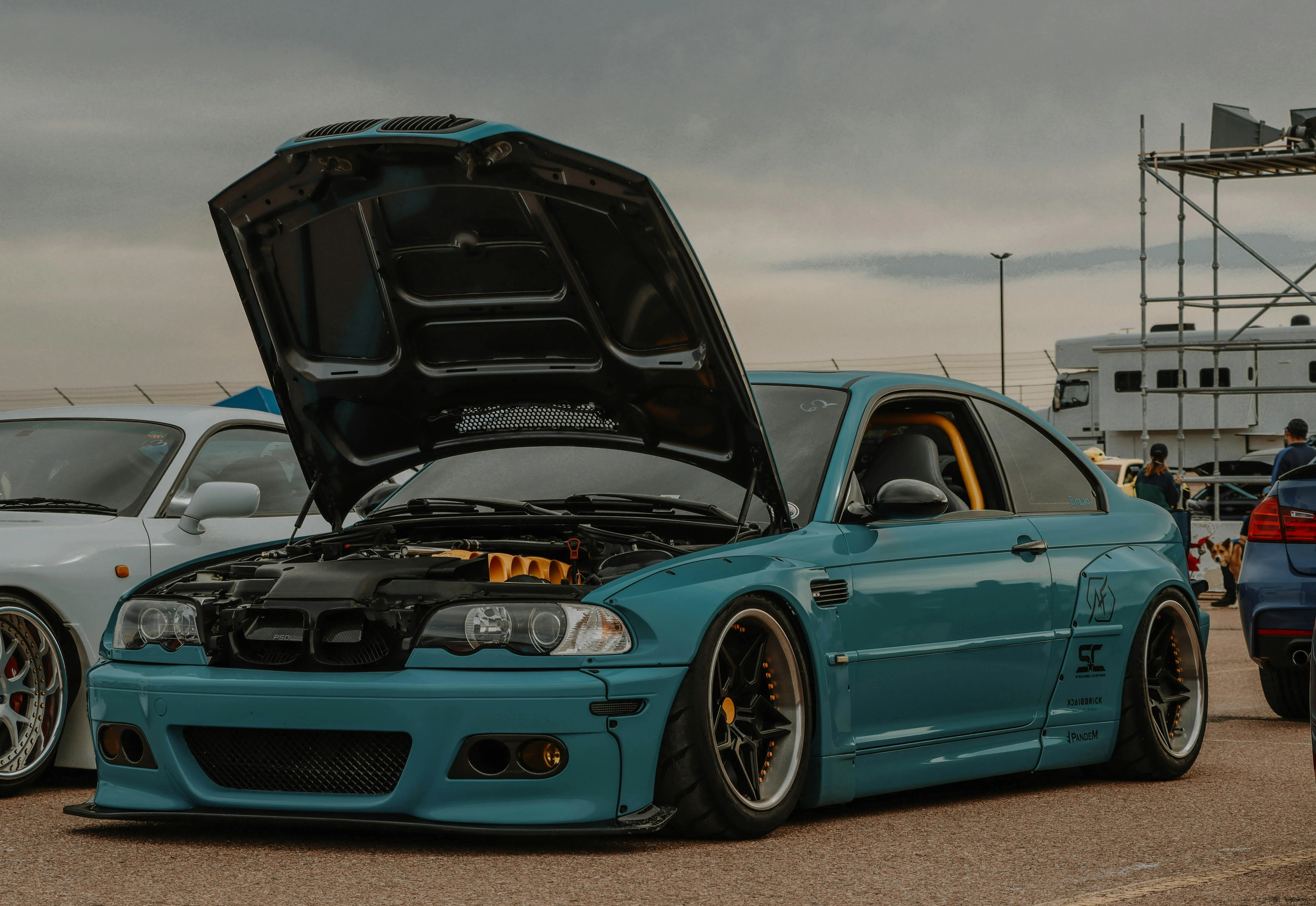 Blue Modified Bmw with Hood Open at Outdoor Event Wallpaper