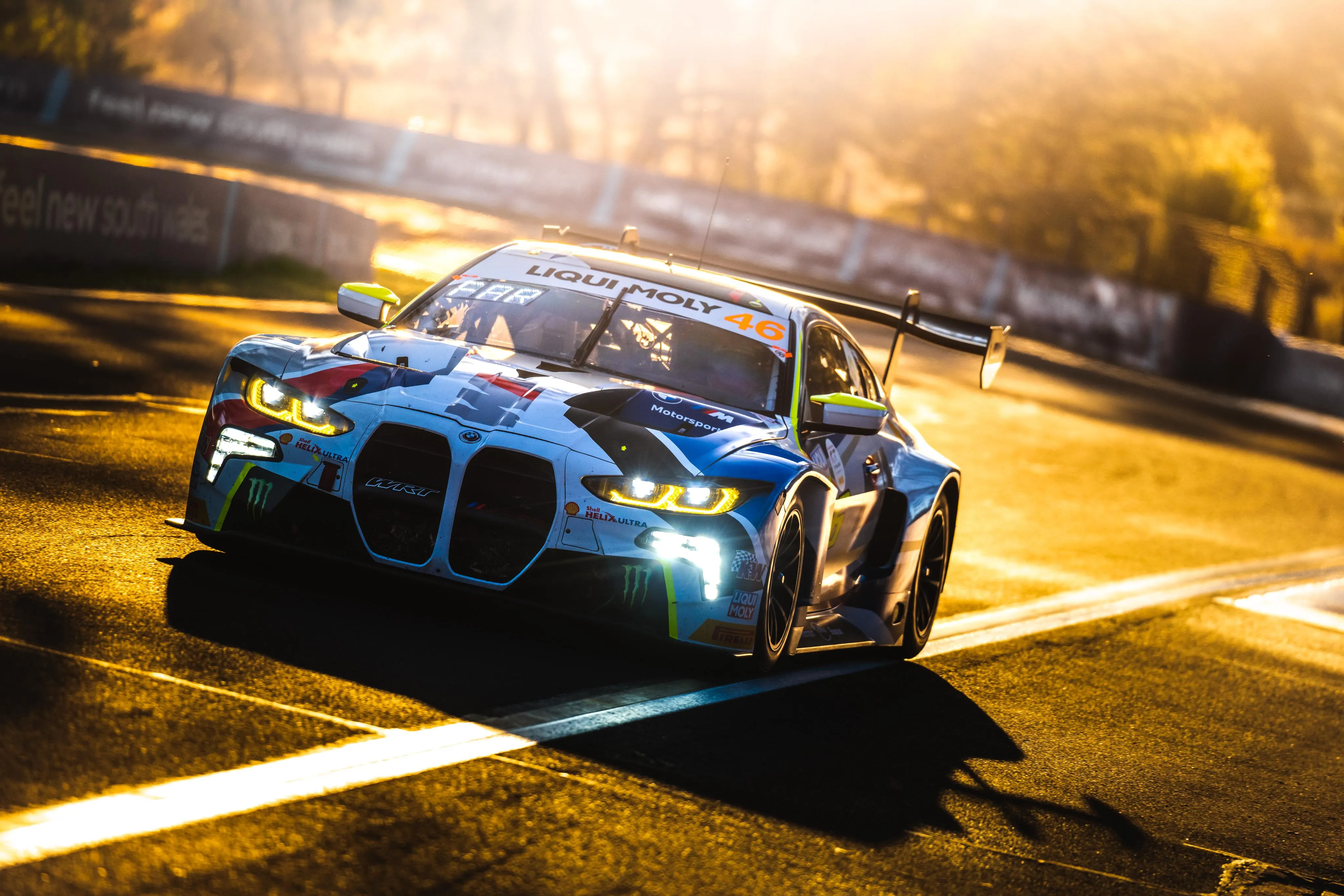 Blue Racing Bmw Taking Sharp Turn at Sunset on Track