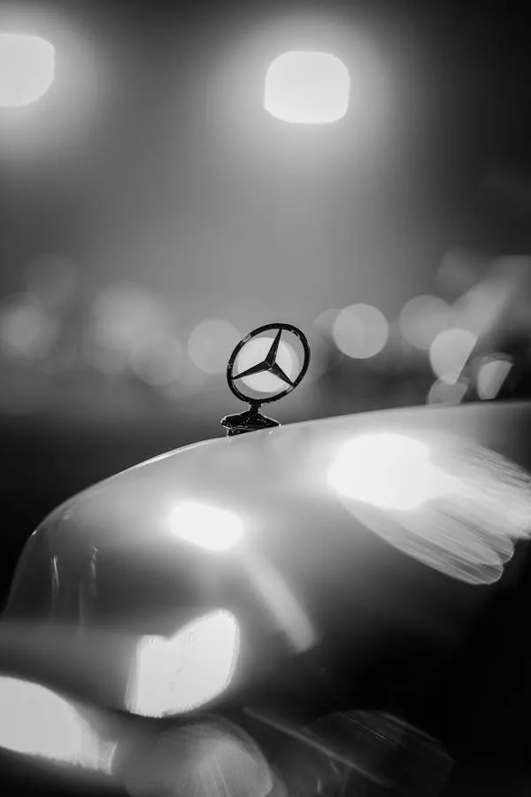 Blurred Mercedes Emblem at Night with Light Reflections image