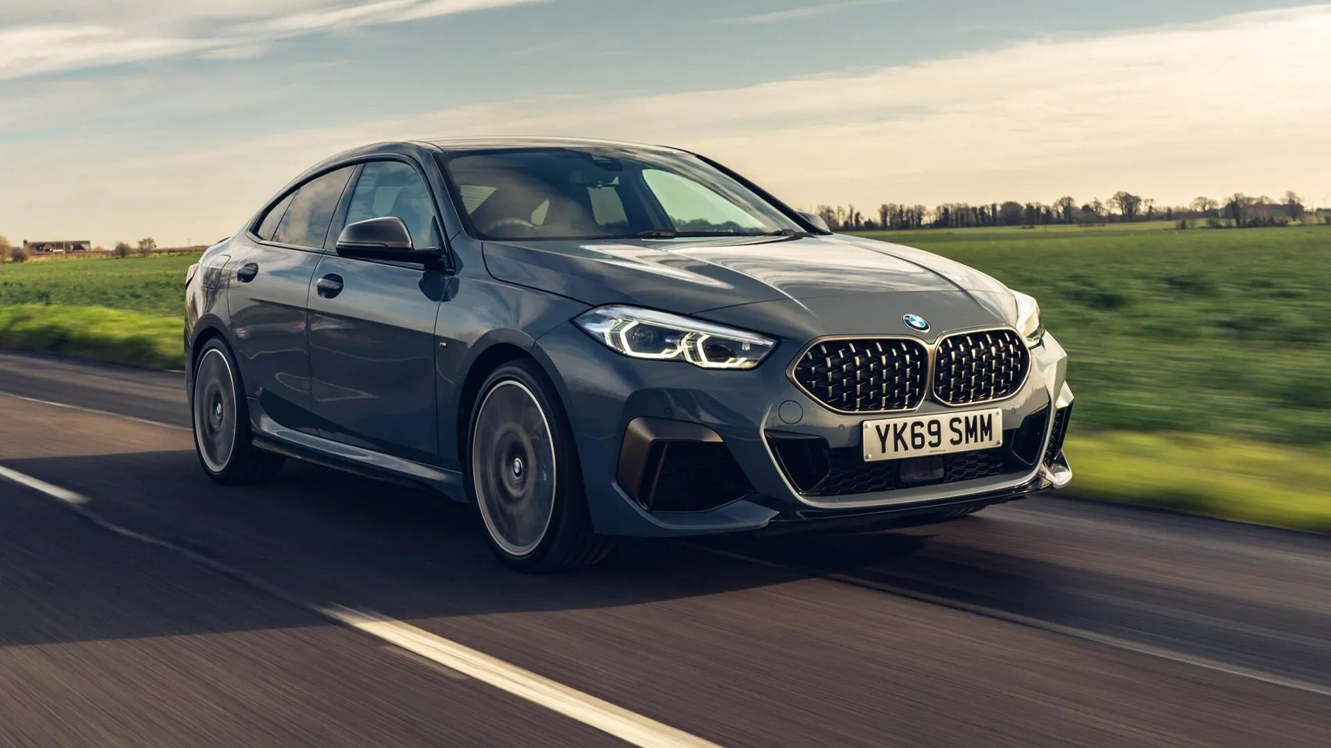 Bmw 1 Series on Road with Scenic Background Wallpaper