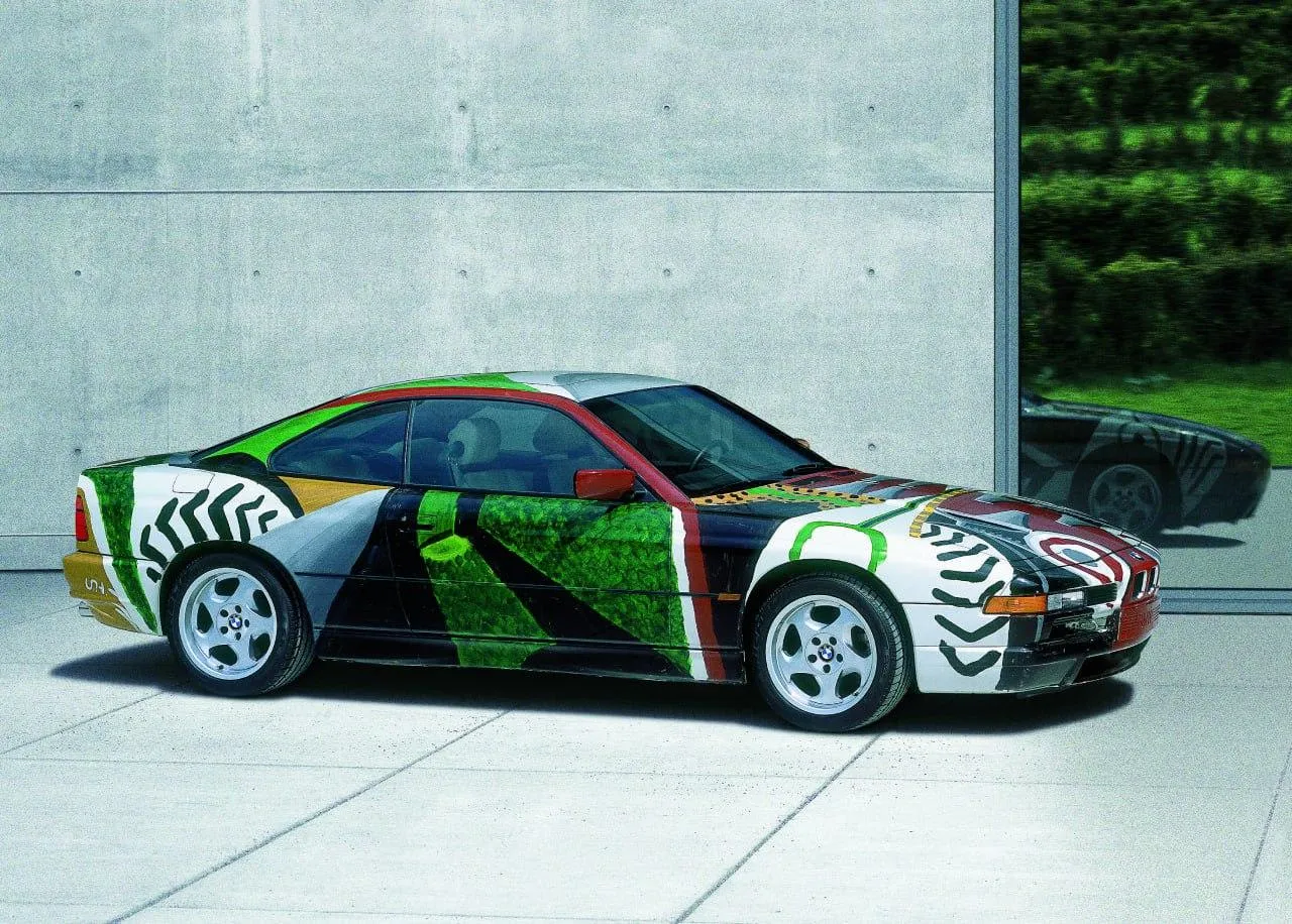Bmw Art Car with Abstract Paint Displayed on Concrete