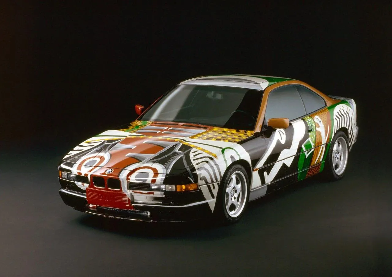 Bmw Art Car with Vibrant Painted Design on Black Floor