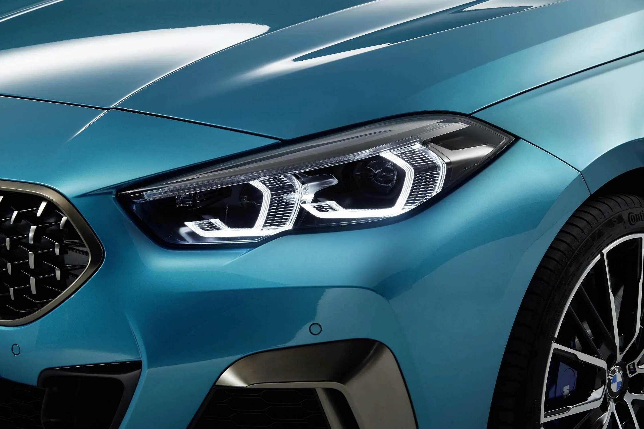 Bmw Blue Sedan Front View with Dynamic Headlights Wallpaper