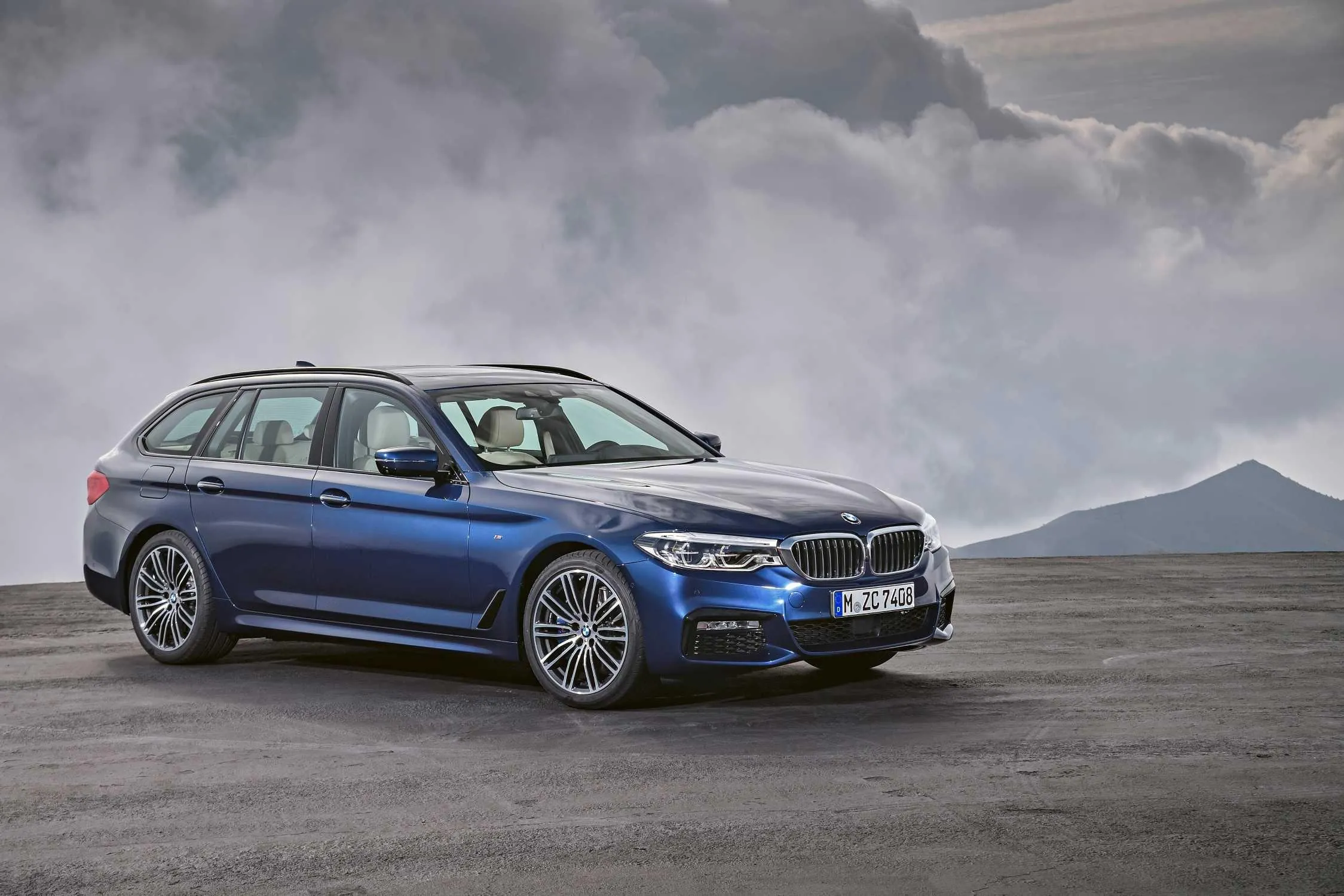 Bmw Blue Station Wagon on Cloudy Day in Open Area Image