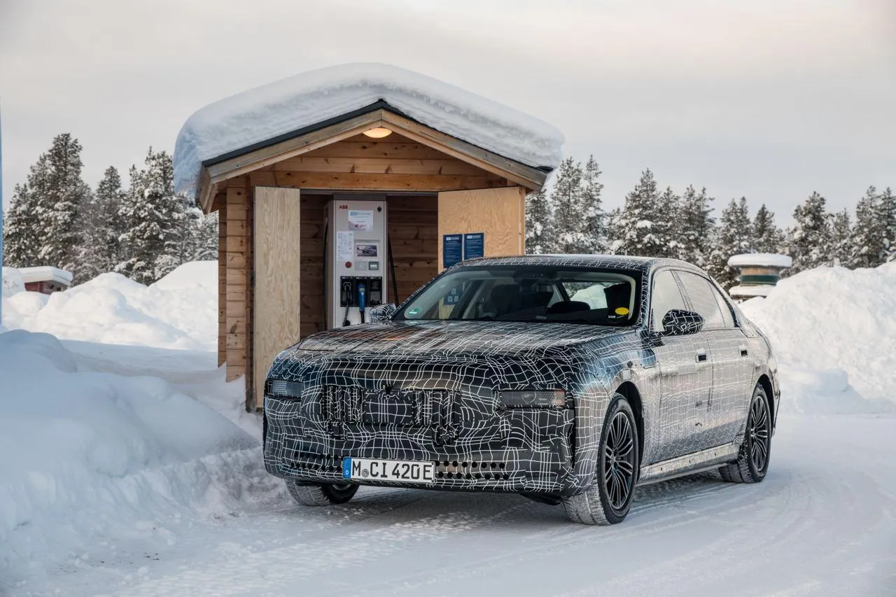 Bmw Car Covered in Snow Parked Next To Wooden Cabin
