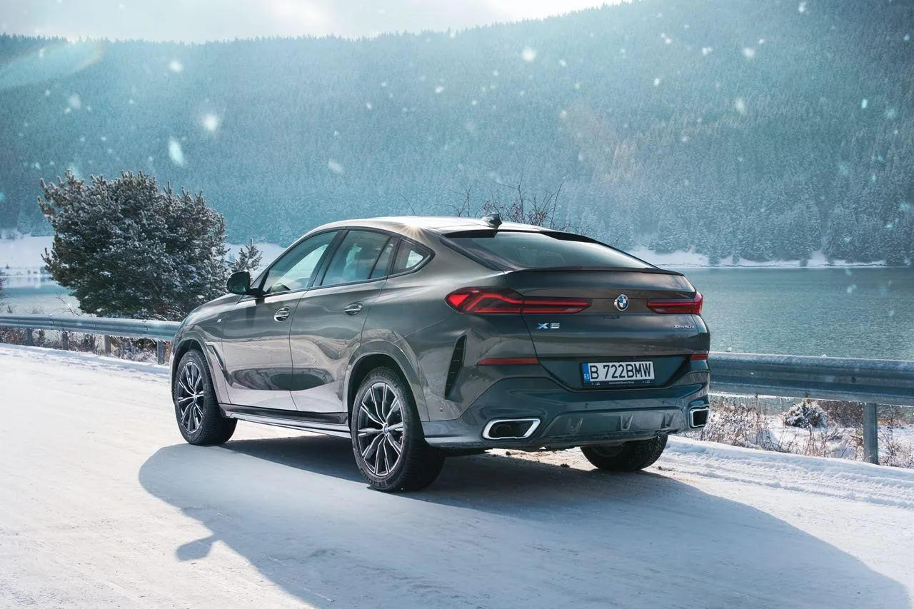 Bmw Car Driving in Snow with an Adventurous Theme Wallpaper