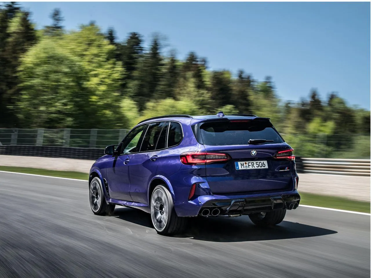 Bmw Car Driving on Highway Surrounded By Lush Greenery