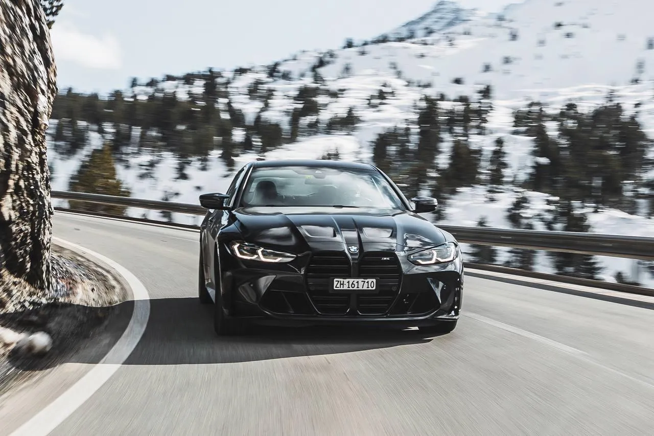 Bmw Car Driving on Snowy Mountain Road with Blurred Background