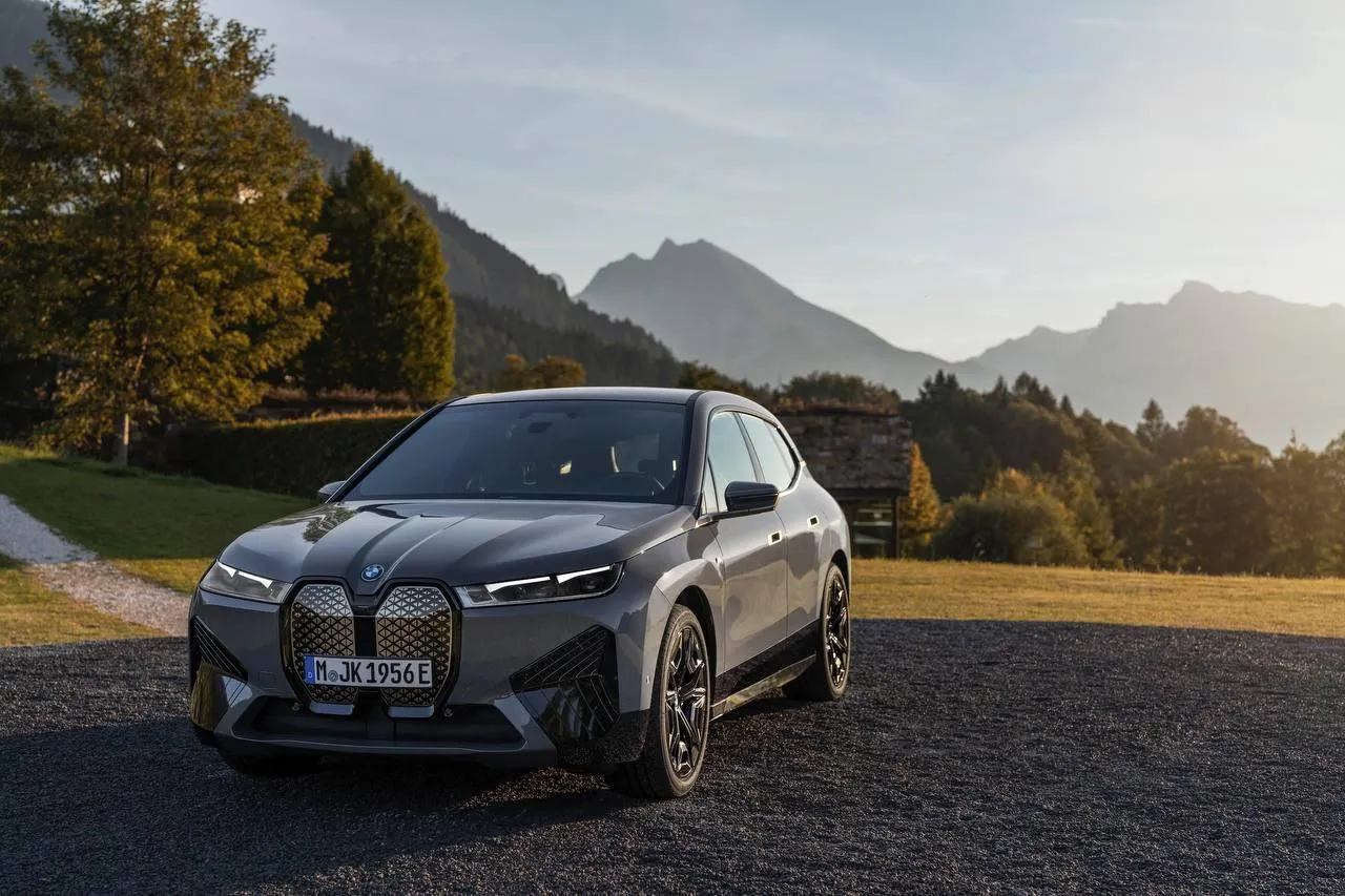 Bmw Car Driving Through Scenic Mountain Road Wallpaper