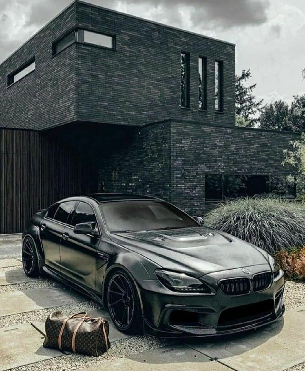 Bmw Car in Front of a Modern Luxury Home with Unique Design