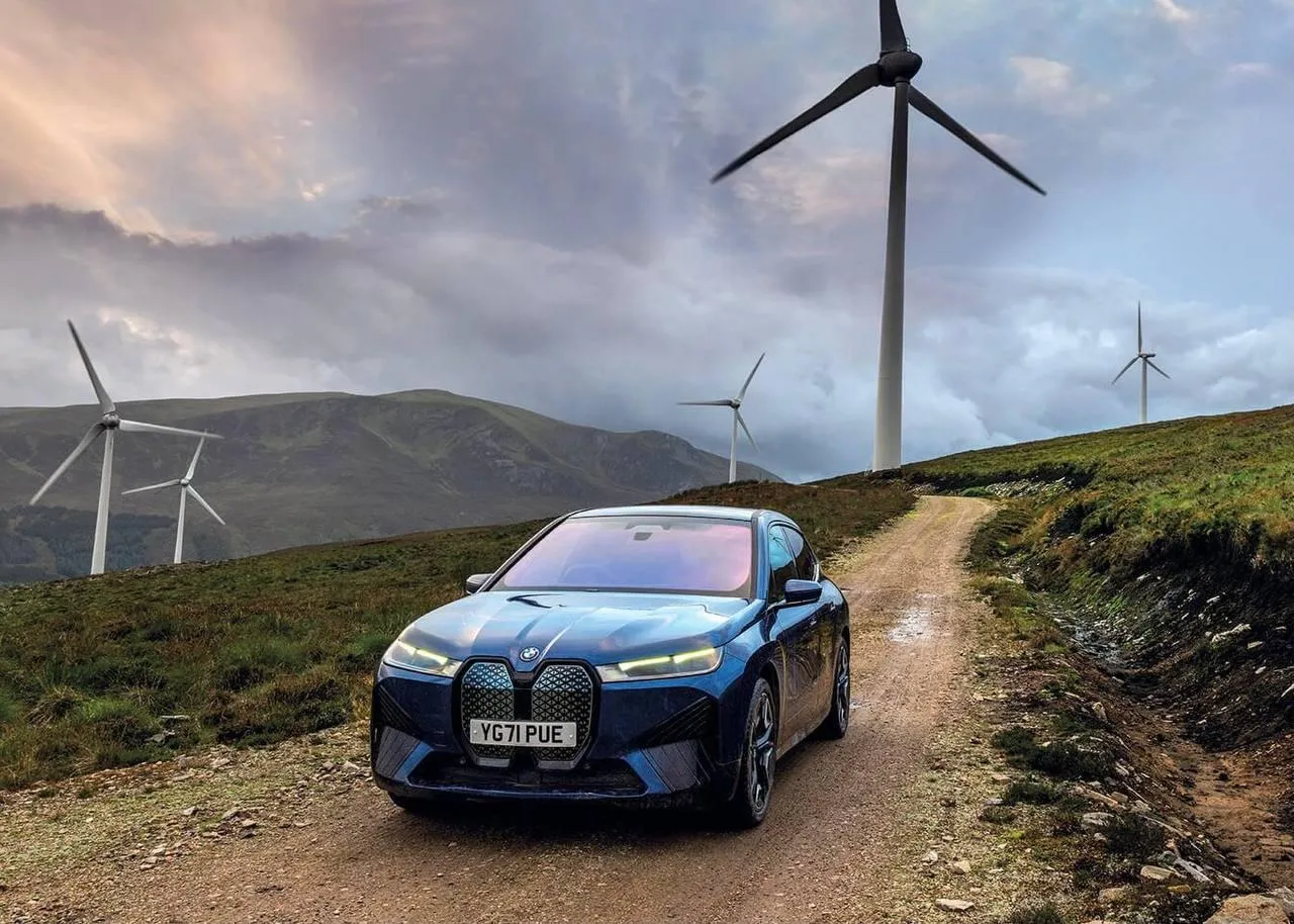 Bmw Car in the Countryside with Wind Turbines Nearby