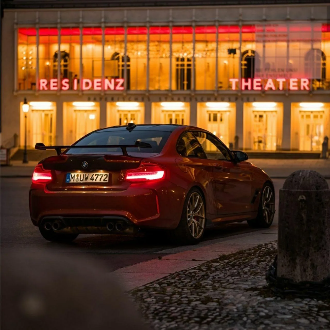 Bmw Car Parked in Front of a Lit Building in the City at Night