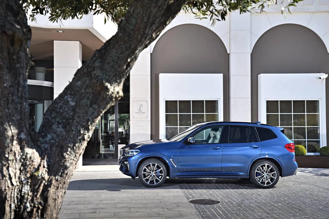 Bmw Car Parked on the Street Near White Building Architecture