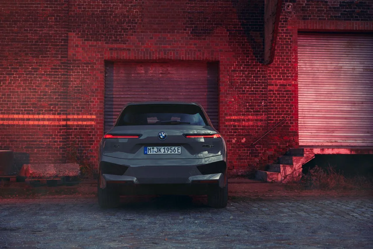 Bmw Car Parked Under Neon Lights in an Industrial Setting