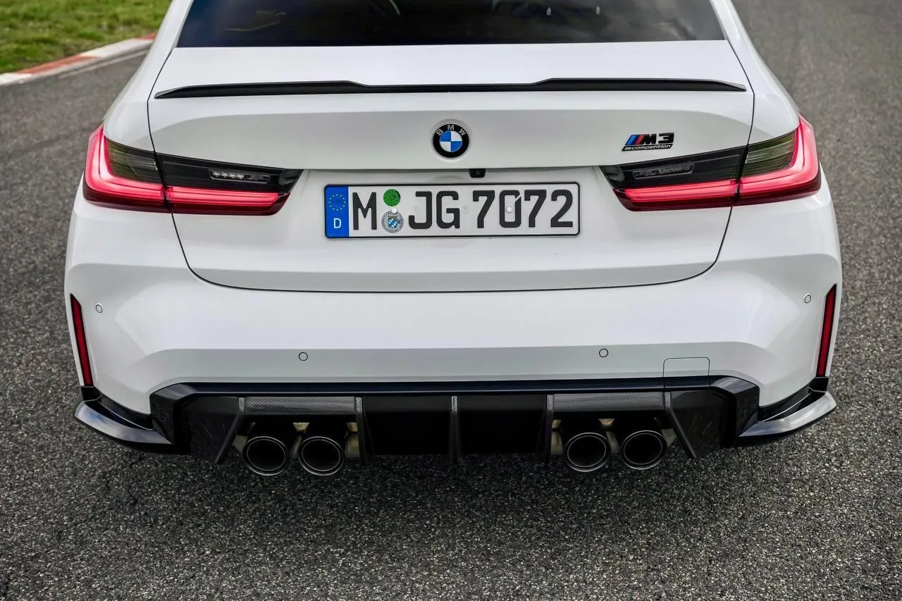 Bmw Car Rear View with Dual Exhaust on Open Road Wallpaper