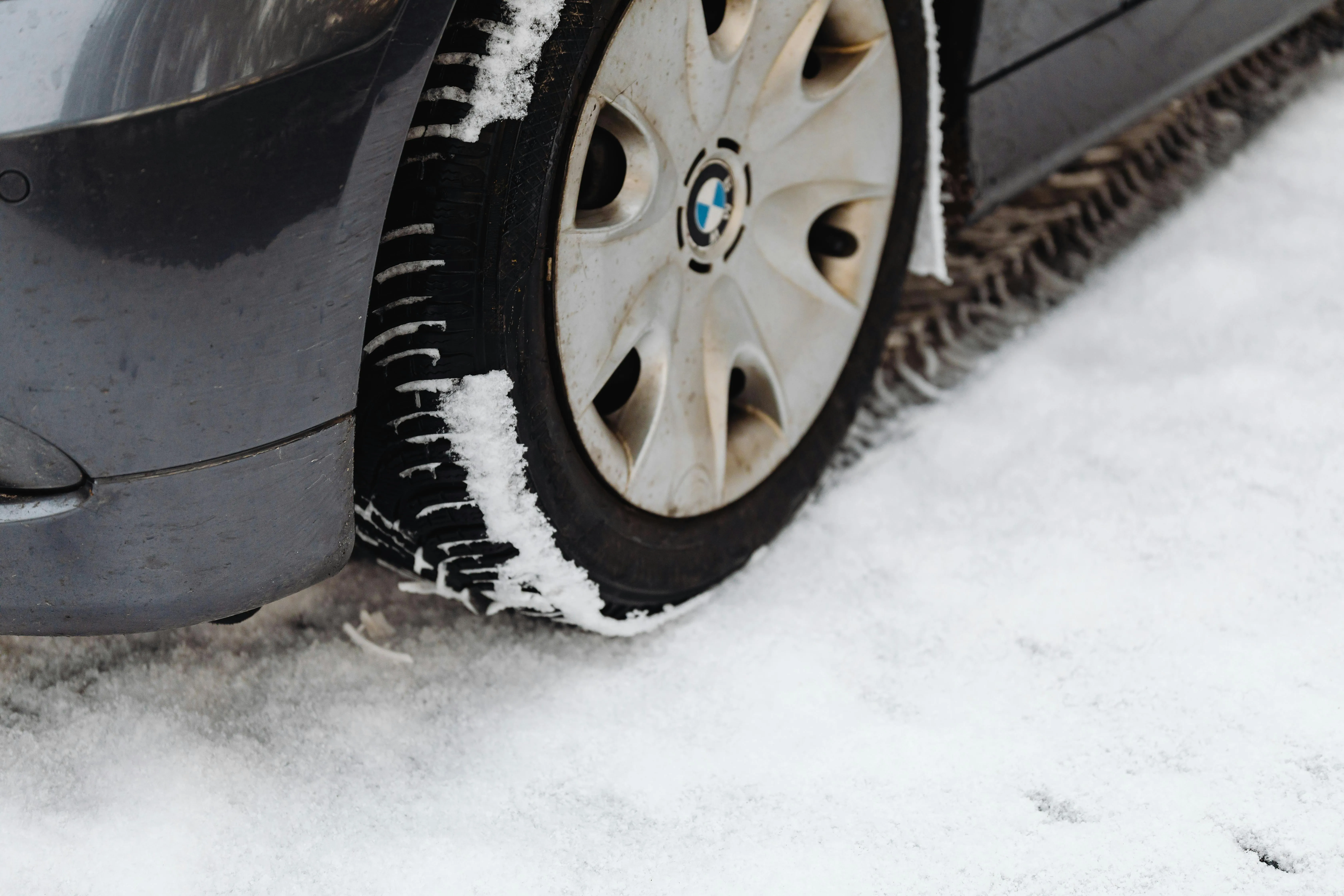 Bmw Car Tire Driving on Snow Covered Winter Road Image