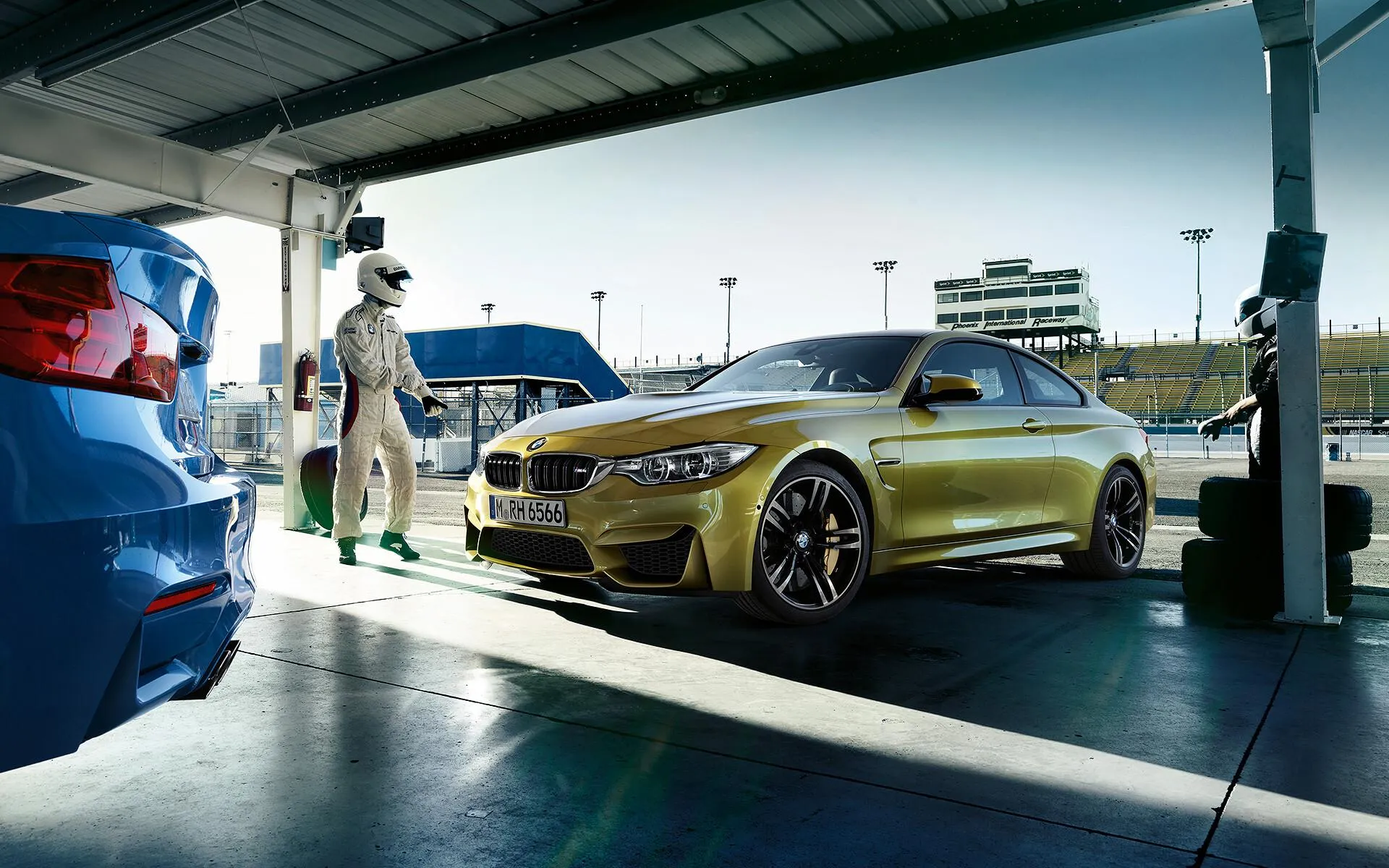 Bmw Cars in Yellow and Blue in a Garage Setting Image