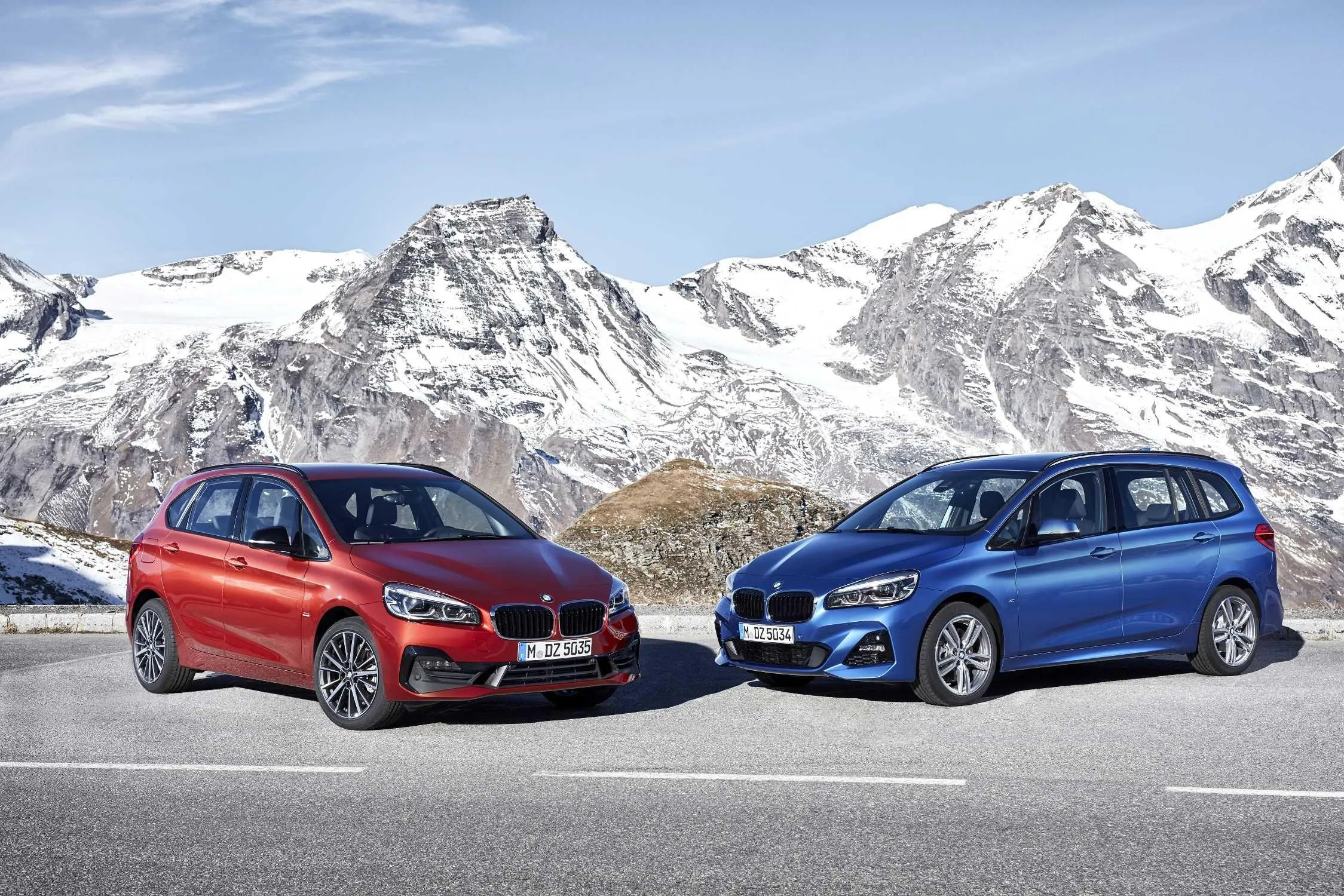 Bmw Cars Posed in Front of Snowy Alpine Mountains Wallpaper