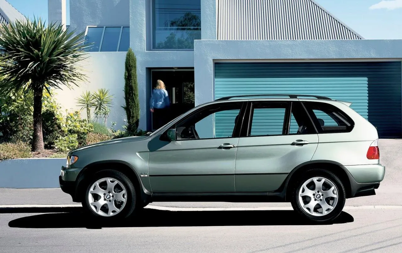 Bmw Compact Car Parked in Front of Modern Building Wallpaper
