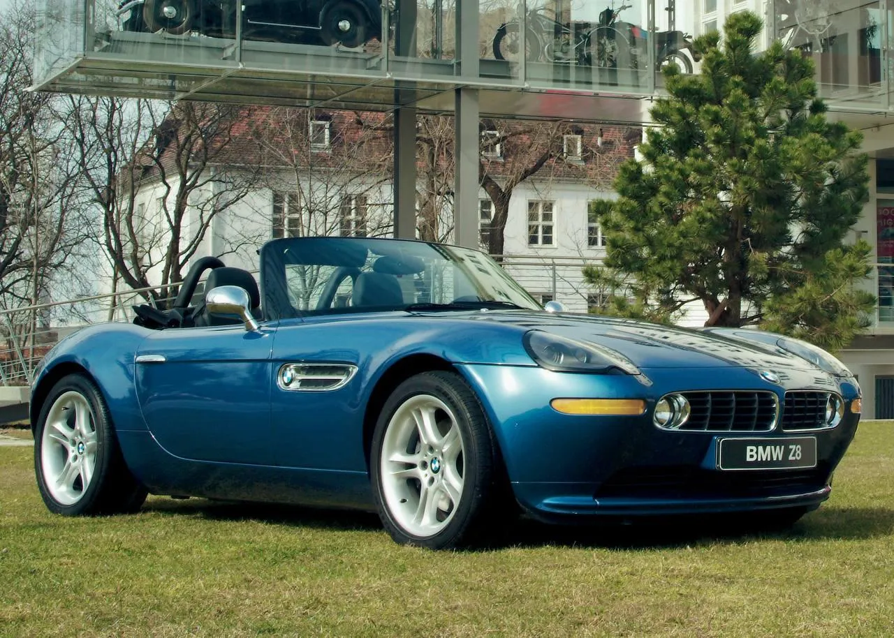Bmw Convertible in Classic Blue on Open Road with Green Trees