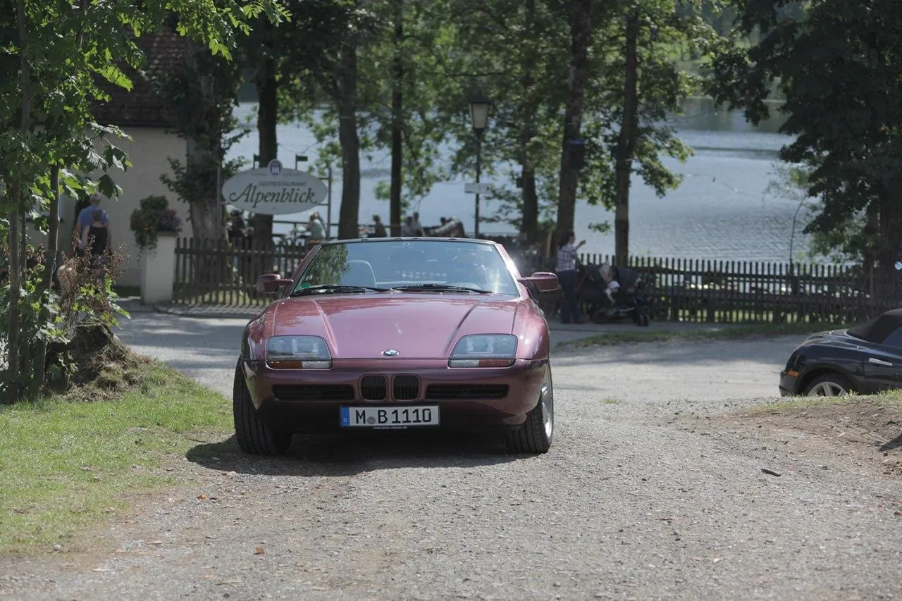 Bmw Convertible Parked Near Lake with Trees and Calm Water