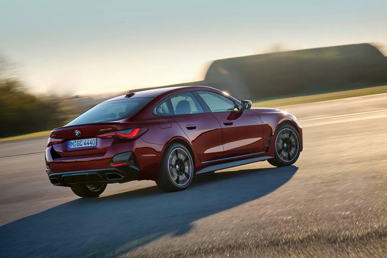Bmw Coupe Driving Into Sunset on Wide Open Mountain Road